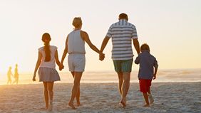 Family on affordable vacation at their beach destination