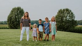 Mom and her kids outside after she teaches them about money