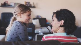 Mom teaching daughter about credit cards.