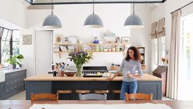 Woman enjoying her kitchen.