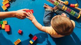 baby playing with blocks on floor