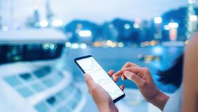 Woman looking at phone with charts