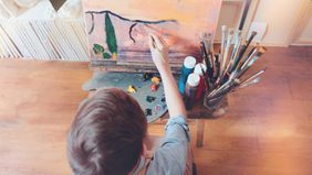 boy painting in anything room