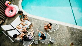 friends and family at a pool party in the backyard 
