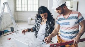 Woman and contractor discussing plans.