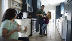 Grandfather dancing with granddaughter who will benefit from his irrevocable life insurance trust.