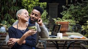 happy couple enjoying coffee at a cafe 
