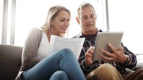Couple looking at a tablet researching whether an annuity is an investment or an insurance policy.