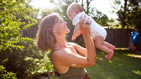 mom and newborn in garden 