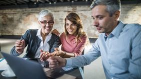 838-mother-and-daughter-at-laptop-with-agent-cosigning-a-mortgage