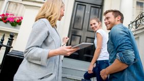 Young couple meeting home inspector. 