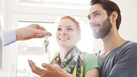 First-time home buyers getting the keys to their new home.