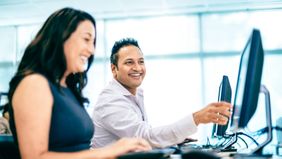 Professor working with a student who found an affordable graduate school option.