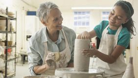 Grandmother and granddaughter doing pottery