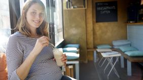 Pregnant woman drinking a smoothie and wondering how long does short-term disability last.