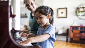 mom and daughter playing piano