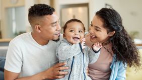 Mom and dad with their baby wondering what’s included in a financial plan