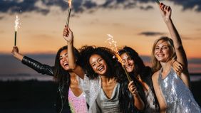women-celebrating-new-year-financial-wins-with-sparklers