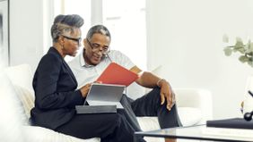 Pre-retirement couple working together on their plans for a long, prosperous retirement.
