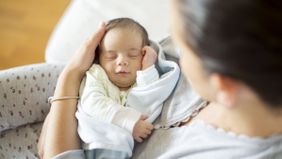 a woman holding a newborn baby