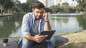 Man reading Northwestern Mutual’s weekly market commentary.