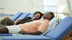 couple relaxing and talking about how to pay less taxes