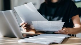 Woman looking up how you calculate your taxes