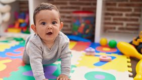 baby playing on mat