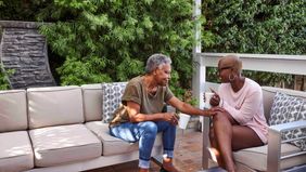 Adult female discussing a serious topic with mother on patio at home 