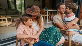 Family sitting on porch outside