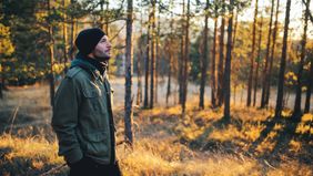 Young man walking in the forest