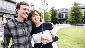 young-couple-walking-outside-drinking-coffee