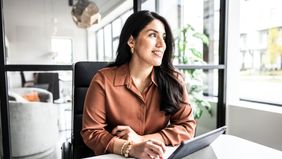 A businesswoman reflects on the importance of diversification and a well-balanced investment portfolio, crafted with her financial advisor at Northwestern Mutual.