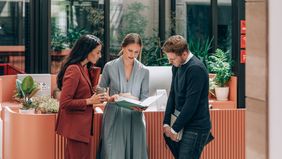 Group of businesspeople discuss financial strategy and investments in modern office