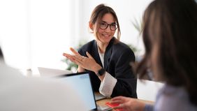 Project leader discussing data with coworker 