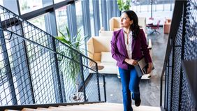 Woman thinking about what she read in Northwestern Mutual’s Quarterly Market Commentary.
