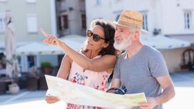 Couple on vacation looking at a map