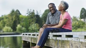 Couple enjoying the beautiful day and talking about the recent market rally.