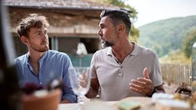 Friends talking about what they read in the latest weekly market commentary from Northwestern Mutual.