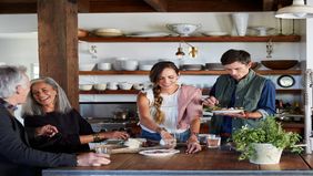 family cooking together in kitchen