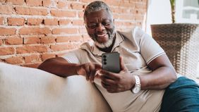 Portrait of man using smartphone at home