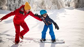 Father and daughter enjoying a winter escape powered by a solid financial plan with Northwestern Mutual.
