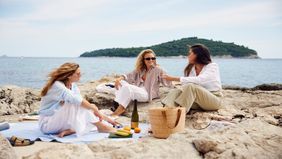 three friends enjoying time on the beach