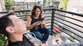 friends hanging out on balcony