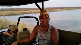 Tasha Danielle riding a Jeep during a tour in South Africa.