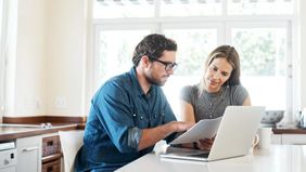 Couple doing finances together on a laptop.