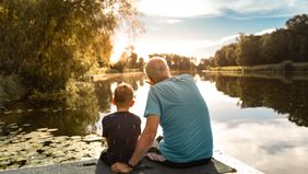 grandfather and grandson on the water