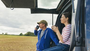 Couple drinking tea outside their van wondering is a 401(k) a retirement plan?