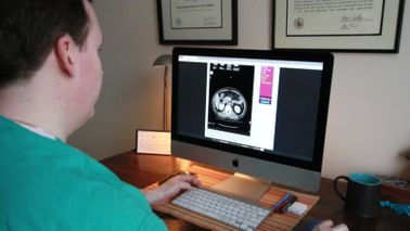 New doctor looking at a patients scan after changing careers