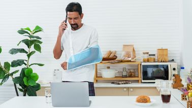 Man at home with injured arm